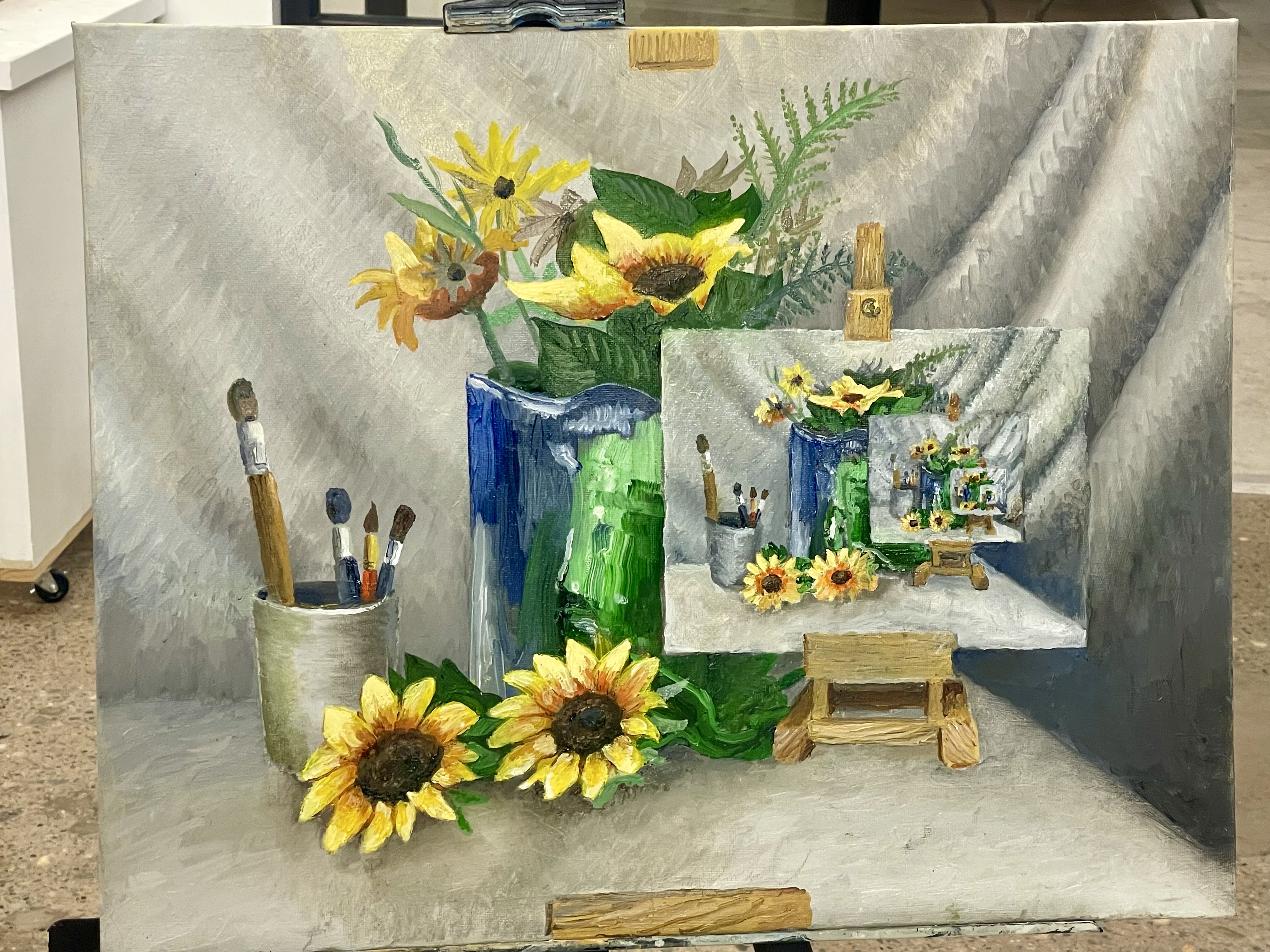 Oil Painting of a still life with sunflowers, paint brushes, and a canvas that is a copy of the same scene over and over in an optical illusion